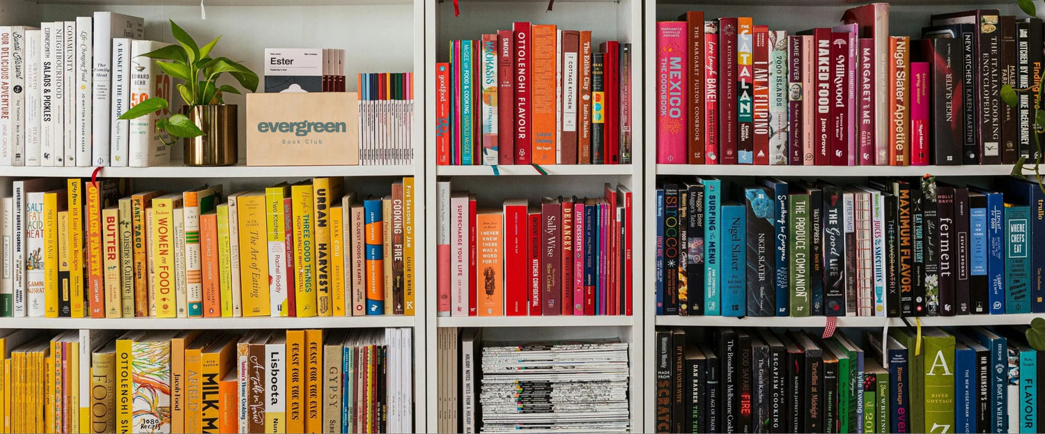 Bookshelf filled with books of various colors and sizes.